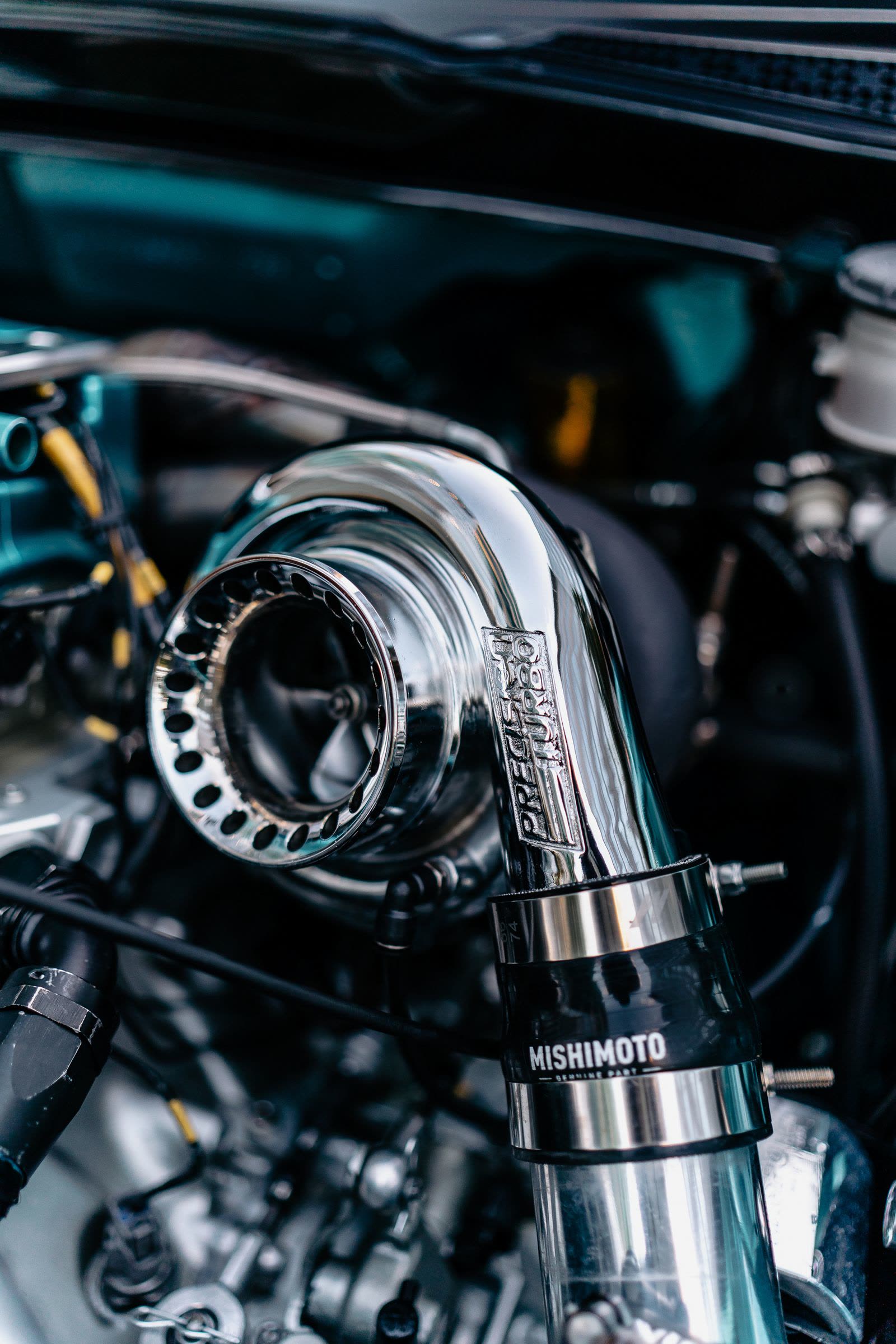 Polished turbocharger and intake piping fitted in a performance engine bay